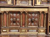 a wooden cabinet that has many different designs on it