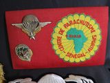 a picture of a group of badges on a red cloth