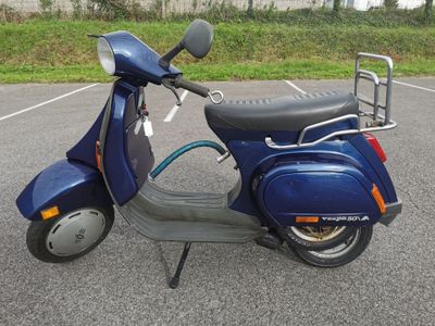 a scooter that is parked in a parking lot