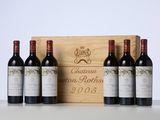 three bottles of wine sit in front of a wooden box