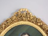 a picture of a woman in a blue dress in a gold frame