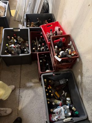 many bottles of beer in the bins on the floor