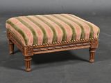 an image of a small ottoman with a striped upholstered seat