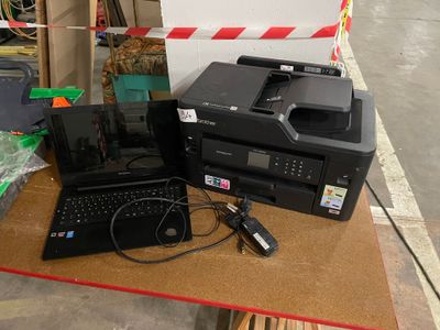 two laptops and a printer sitting on a table