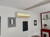 an image of a living room with a air conditioner on the wall