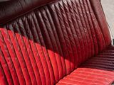 an image of a red and black car seat in a car
