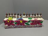figurines of a group of people sitting on top of a cake