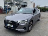 the audi e - trc is parked in front of a building