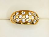 a close up of a gold ring with diamonds on it