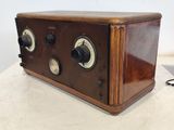 an old fashioned radio sitting on top of a table next to a mouse