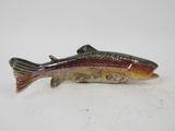 a close up of a fish figurine on a white surface