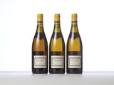 three bottles of wine sitting on top of a table next to each other