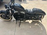 a black motorcycle that is parked in the driveway