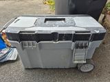 a black and gray tool box sitting on the ground