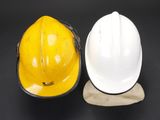 two hard hats sitting next to each other on a table