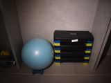a blue ball sitting next to a stack of books and a blue exercise ball