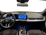 the interior of a car with a steering wheel, dashboard, and display screen