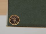 an image of a green book with a gold emblem on it
