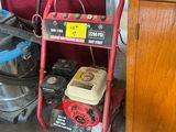 un chariot rouge équipé d'un aspirateur, à côté d'une armoire