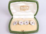 three cuff watches in a case on a white surface