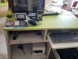a computer desk with a monitor and keyboard on it