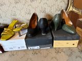 several pairs of women ' s shoes are lined up on boxes