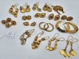 some of the gold jewelry is laying out on the table