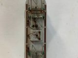 a small boat that is sitting on a white surface