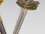 pair of two swords with gold decoration on a white background