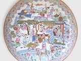 a plate with a painting on it on the wall