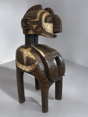 an image of a wooden sculpture of a horse on a white surface