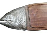 a wooden cutting board with a fish on it