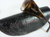 pair of sunglasses with a case and a pair of sunglasses on a white surface