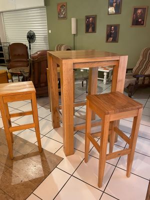 deux tabourets en bois et une table dans un salon