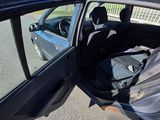 a car that is parked on the side of the road with its door open