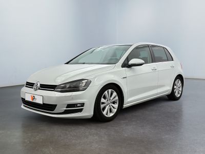 the white volkswagen golf is parked in a large room