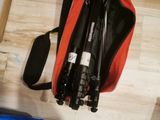 a bag with a camera and a tripod on the floor