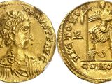 a gold coin with an image of a man holding a sword