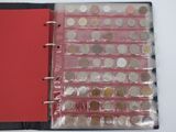 a red book with a bunch of coins inside of it