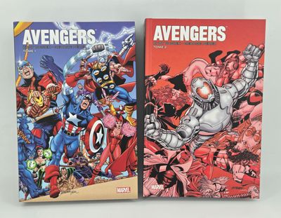 two books of avengers comics on a white surface