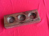a small wooden box with three different knobs on it