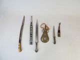 five different types of knives on a white surface