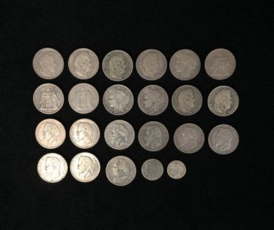 a lot of silver coins on a black surface