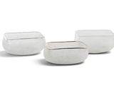 three white vases sitting next to each other on a white surface