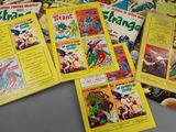 a lot of comic books that are on the table