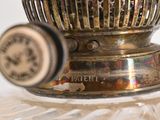 a silver bowl with a clock on it on a table