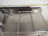 a stainless steel table with three pans on top of it