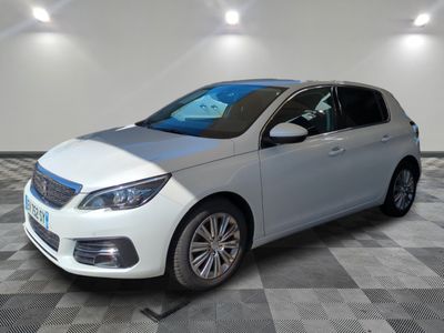the white car is parked on a checkered floor in the garage