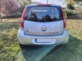 a small silver car that is parked in the grass