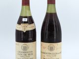 two bottles of wine sitting next to each other on a white surface